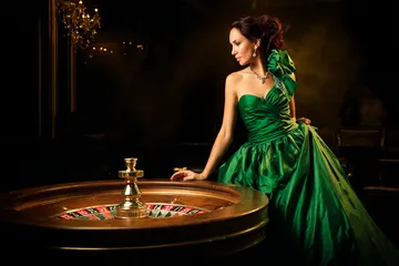A stylish woman beside vibrant slot machines displaying glowing sevens, showcasing the variety of top slots at 588WINBD.